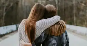 Friends with arms around each others shoulders