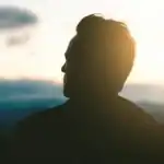 A man looking back, reflecting on life choices